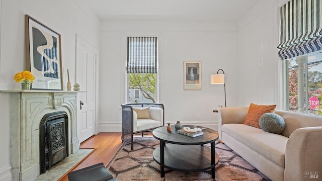 643 3rd St, Napa, CA 94559 - living area with light wood-type flooring, baseboards, and a fireplace with flush hearth