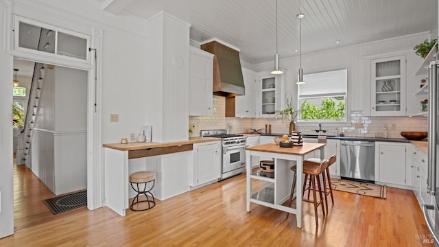 643 3rd St, Napa, CA 94559 - kitchen featuring wood counters, crown molding, tasteful backsplash, and appliances with stainless steel finishes