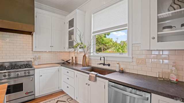 643 3rd St, Napa, CA 94559 - kitchen featuring a sink, white cabinets, dark countertops, and appliances with stainless steel finishes