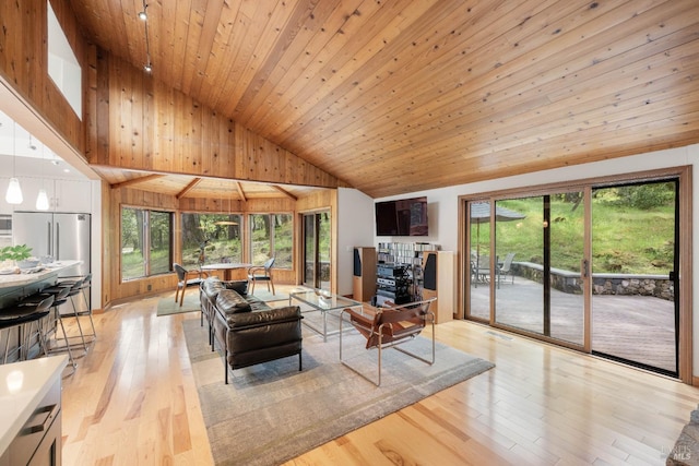 living area featuring light wood finished floors, wooden ceiling, a wealth of natural light, and high vaulted ceiling