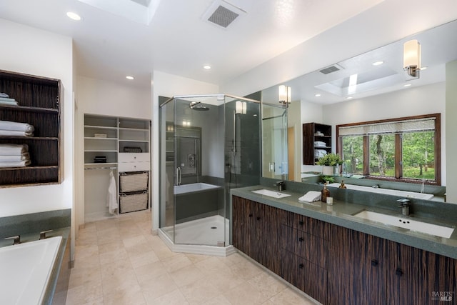 full bath with visible vents, a shower stall, and a sink