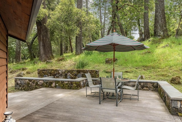 wooden terrace featuring outdoor dining area