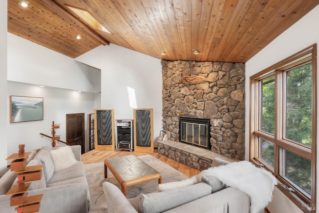 living area featuring wood ceiling, light wood-style flooring, a fireplace, vaulted ceiling with beams, and recessed lighting