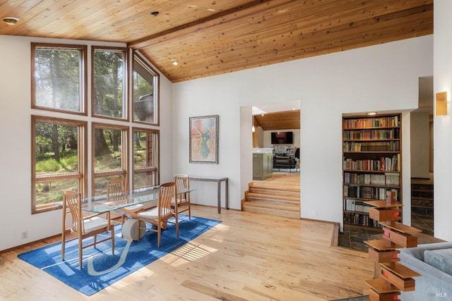 sitting room featuring wooden ceiling, light wood-type flooring, stairs, and high vaulted ceiling