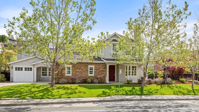 view of front of home with fence, stone siding, concrete driveway, a garage, and a front yard
