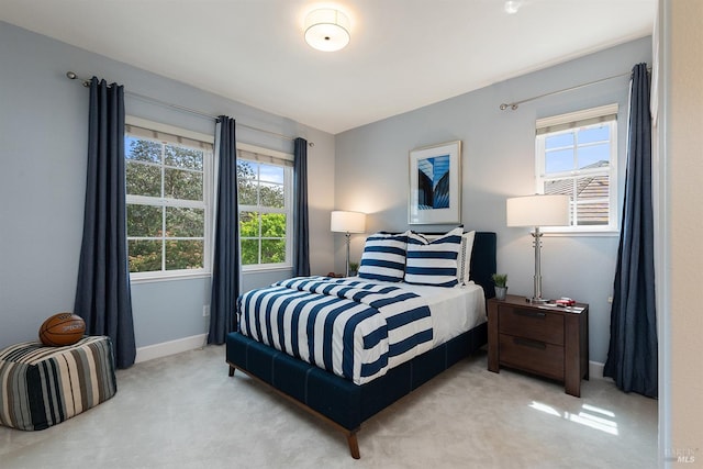 carpeted bedroom featuring baseboards
