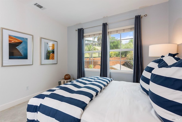 bedroom with carpet flooring, visible vents, and baseboards