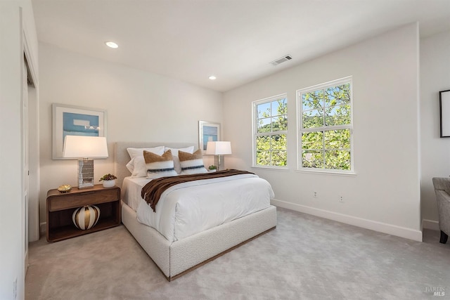 carpeted bedroom featuring baseboards, visible vents, and recessed lighting