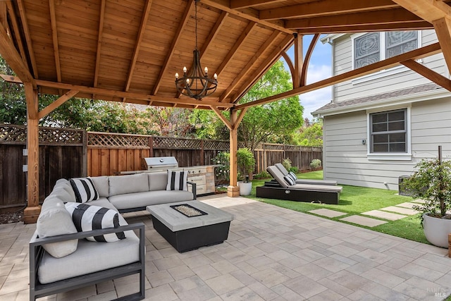 view of patio / terrace featuring a fenced backyard, an outdoor living space with a fire pit, and area for grilling