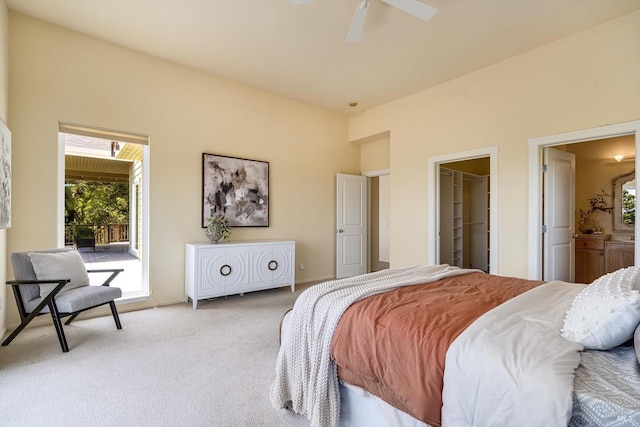 bedroom with ceiling fan, light carpet, and connected bathroom
