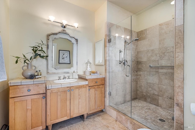 bathroom with tile patterned floors, vanity, and a shower stall