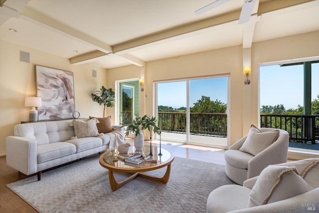living room with coffered ceiling, wood finished floors, and beamed ceiling