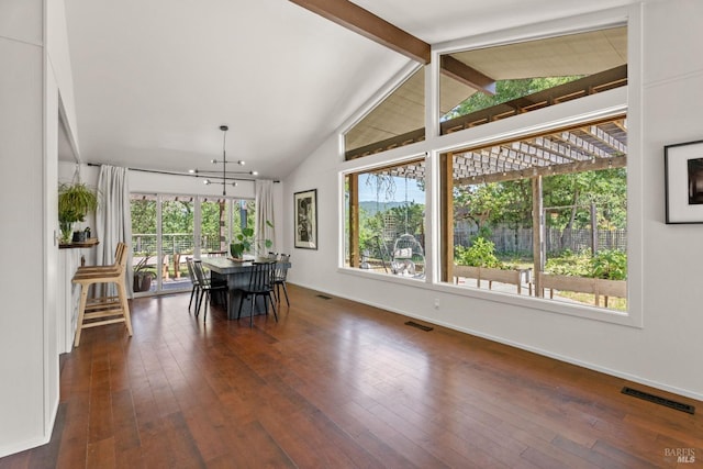 dining room with visible vents, hardwood / wood-style flooring, and vaulted ceiling with beams