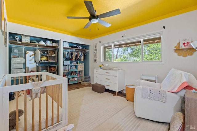 bedroom with a crib and wood finished floors
