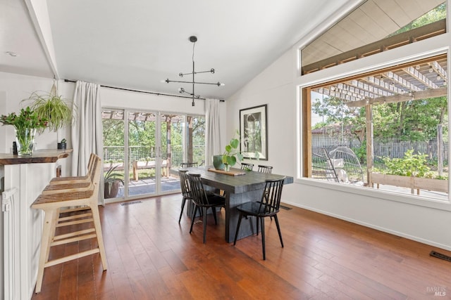 dining room featuring lofted ceiling, baseboards, visible vents, and plenty of natural light