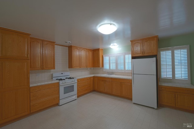 504 C St, San Rafael, CA 94901 - kitchen featuring backsplash, tile counters, white appliances, and a sink
