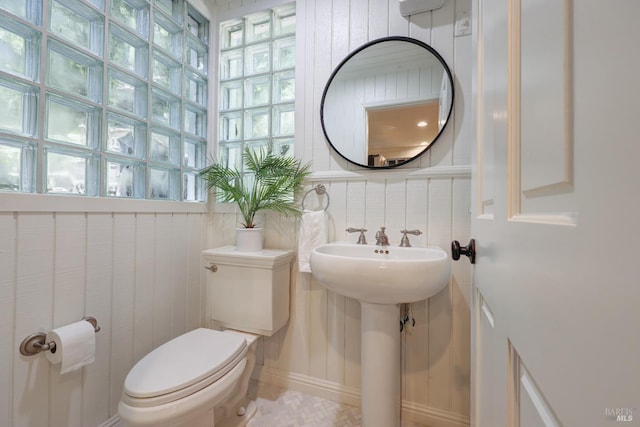 half bathroom featuring toilet and a sink