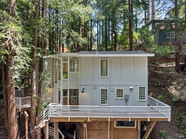 rear view of property with a wooden deck
