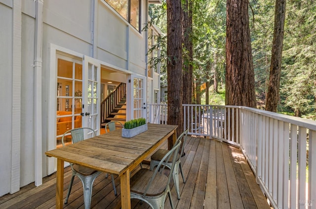 deck with french doors and outdoor dining space