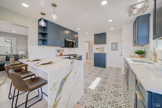 948 Benicia Rd, Vallejo, CA 94591 - kitchen with stainless steel appliances, a sink, a peninsula, a kitchen bar, and light stone countertops