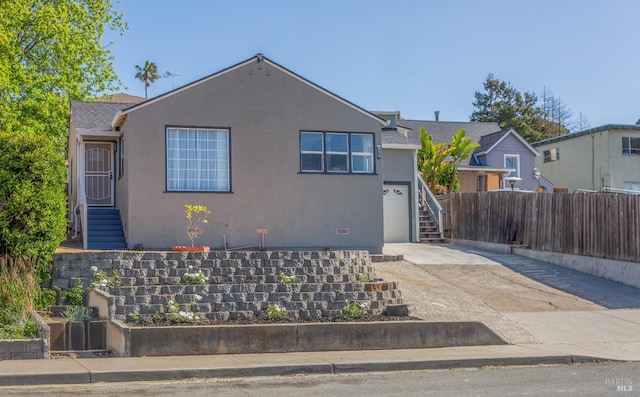948 Benicia Rd, Vallejo, CA 94591 - view of front of property featuring concrete driveway, stucco siding, fence, a garage, and stairway