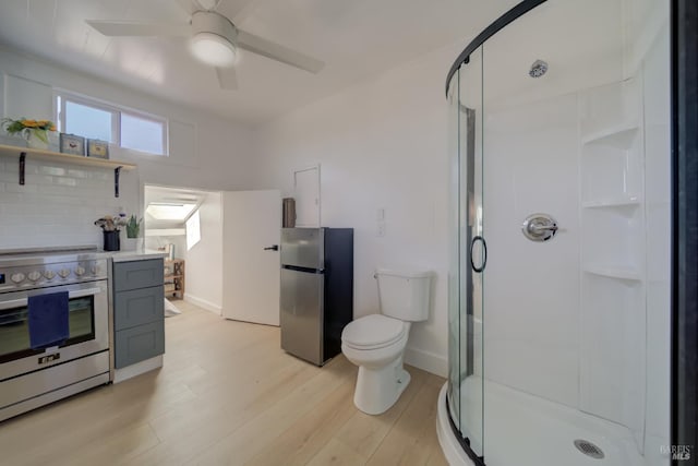 948 Benicia Rd, Vallejo, CA 94591 - bathroom featuring a stall shower, toilet, a ceiling fan, wood finished floors, and baseboards