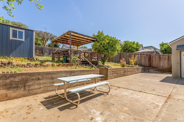 948 Benicia Rd, Vallejo, CA 94591 - view of patio with a fenced backyard, outdoor dining area, an outdoor structure, a wooden deck, and stairs