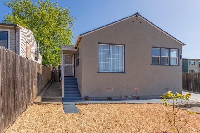 948 Benicia Rd, Vallejo, CA 94591 - view of front facade featuring stucco siding, fence, and crawl space