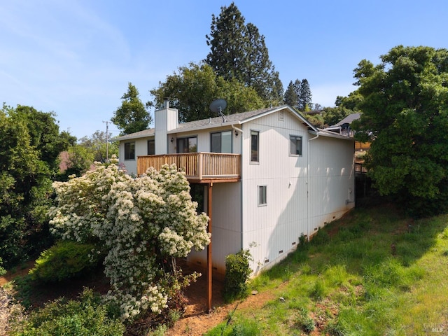 view of side of home featuring a chimney