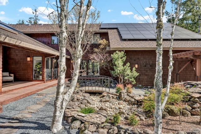 40 Los Pinos, Nicasio, CA 94946 - back of property featuring a wooden deck, a shingled roof, and roof mounted solar panels