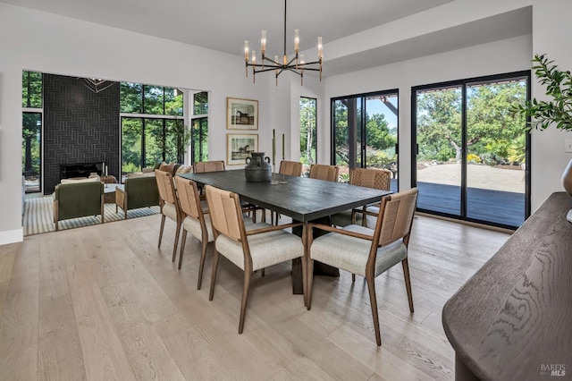 40 Los Pinos, Nicasio, CA 94946 - dining room featuring a large fireplace, light wood-style flooring, and a notable chandelier