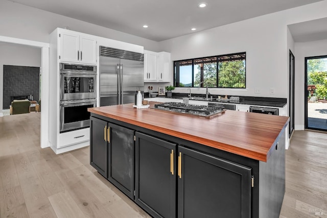 40 Los Pinos, Nicasio, CA 94946 - kitchen featuring stainless steel appliances, butcher block counters, light wood-type flooring, and white cabinets