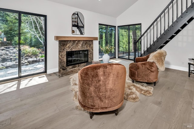 40 Los Pinos, Nicasio, CA 94946 - living room with baseboards, a healthy amount of sunlight, a fireplace, and wood finished floors