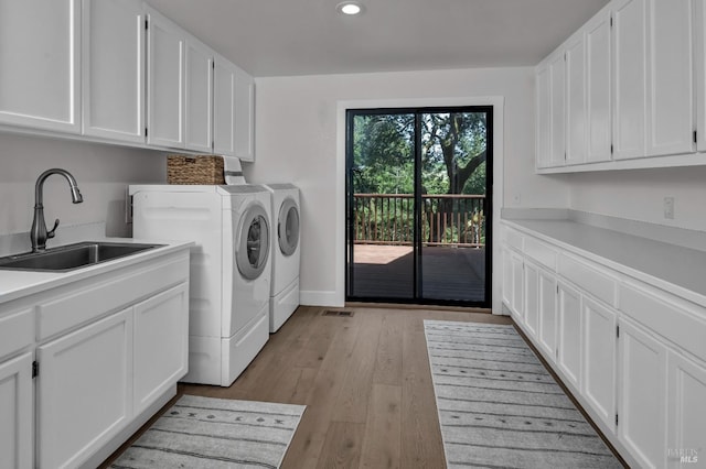 40 Los Pinos, Nicasio, CA 94946 - clothes washing area featuring light wood-style flooring, recessed lighting, a sink, washing machine and clothes dryer, and cabinet space
