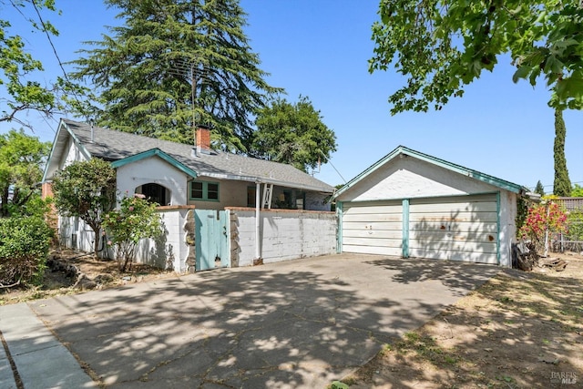 1531 F St, Napa, CA 94559 - view of front of property featuring a chimney, an outdoor structure, fence, and a detached garage
