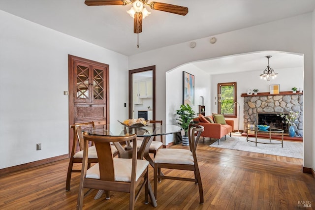 1531 F St, Napa, CA 94559 - dining space featuring wood-type flooring, arched walkways, a ceiling fan, baseboards, and a stone fireplace