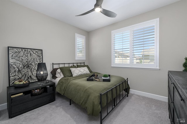 carpeted bedroom featuring baseboards and ceiling fan