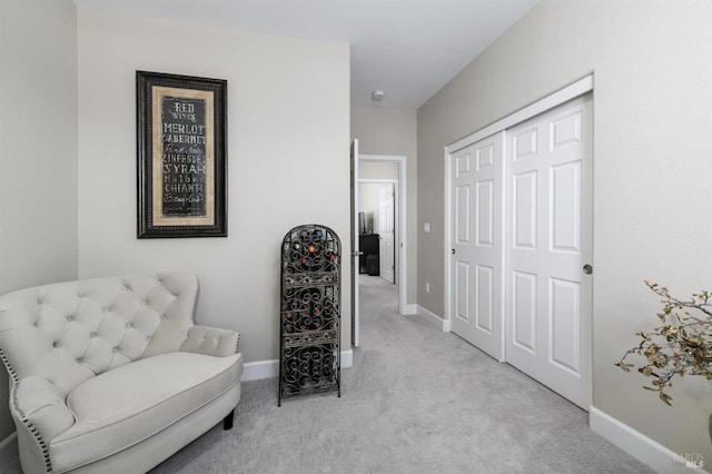 living area with light carpet and baseboards