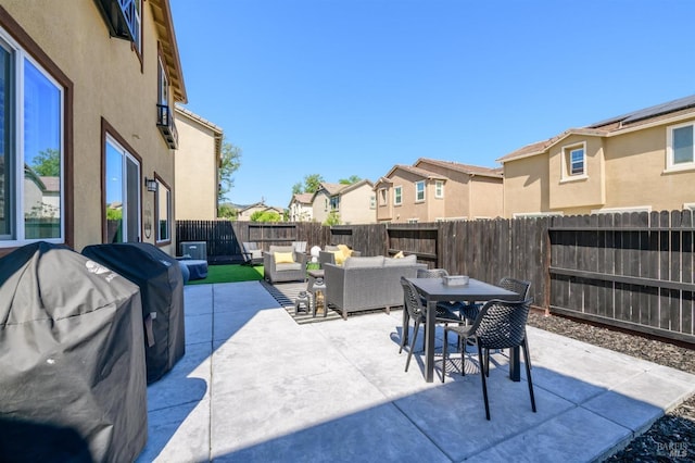 view of patio with a fenced backyard, outdoor dining area, a residential view, and an outdoor living space