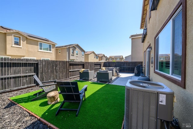 view of yard featuring a residential view, outdoor lounge area, central air condition unit, a fenced backyard, and a patio area