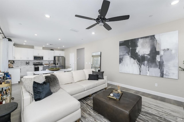 living room with recessed lighting, baseboards, visible vents, ceiling fan, and light wood-type flooring