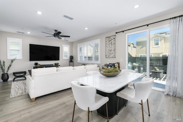 dining room with light wood-type flooring, recessed lighting, ceiling fan, and visible vents