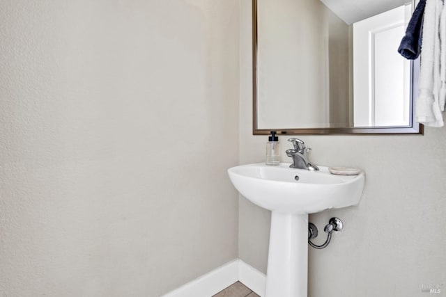 bathroom featuring baseboards and tile patterned flooring