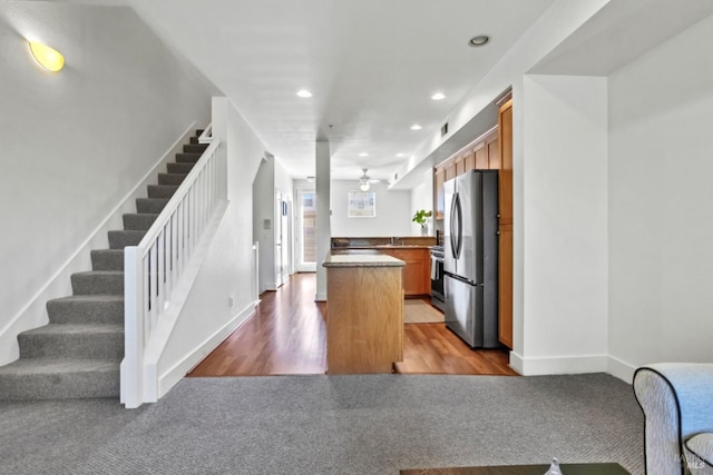 kitchen featuring a peninsula, freestanding refrigerator, carpet, visible vents, and recessed lighting