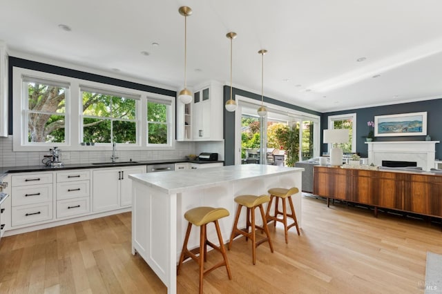 11 Heather Way, Larkspur, CA 94939 - kitchen featuring light wood-type flooring, a sink, backsplash, and white cabinets