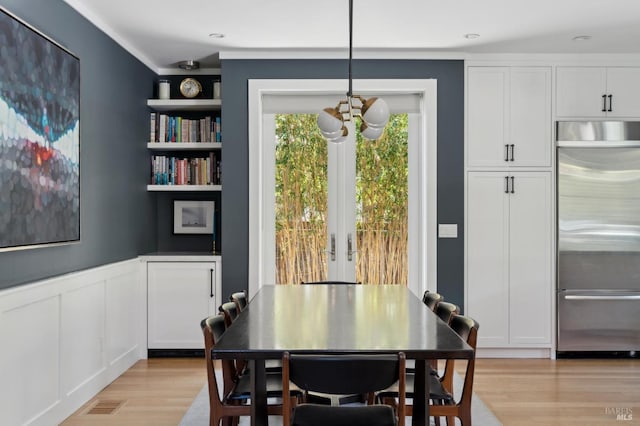 11 Heather Way, Larkspur, CA 94939 - dining area featuring light wood-style floors, french doors, wainscoting, crown molding, and a decorative wall