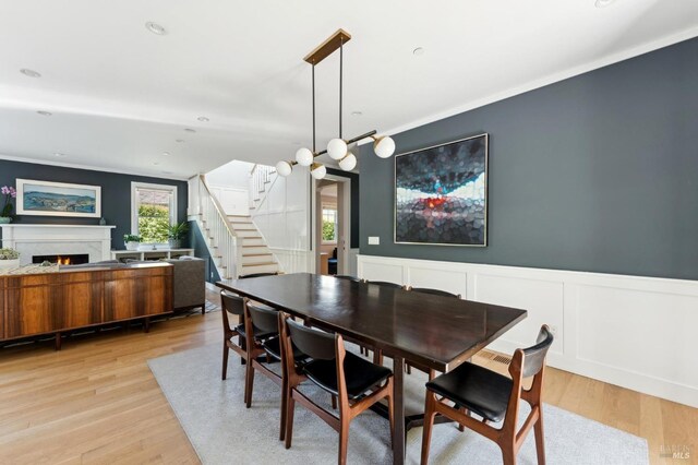 11 Heather Way, Larkspur, CA 94939 - dining area with stairs, wainscoting, light wood-style flooring, a premium fireplace, and a decorative wall