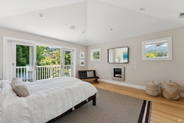 11 Heather Way, Larkspur, CA 94939 - bedroom featuring access to outside, baseboards, light wood-type flooring, a glass covered fireplace, and vaulted ceiling