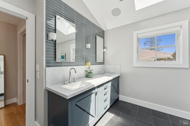 11 Heather Way, Larkspur, CA 94939 - bathroom featuring double vanity, lofted ceiling, backsplash, baseboards, and a skylight