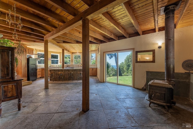 32211 Condor Rd, Willits, CA 95490 - interior space featuring a wood stove, plenty of natural light, wood ceiling, and stone tile flooring